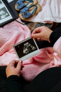 Woman looking at picture of sonogram.